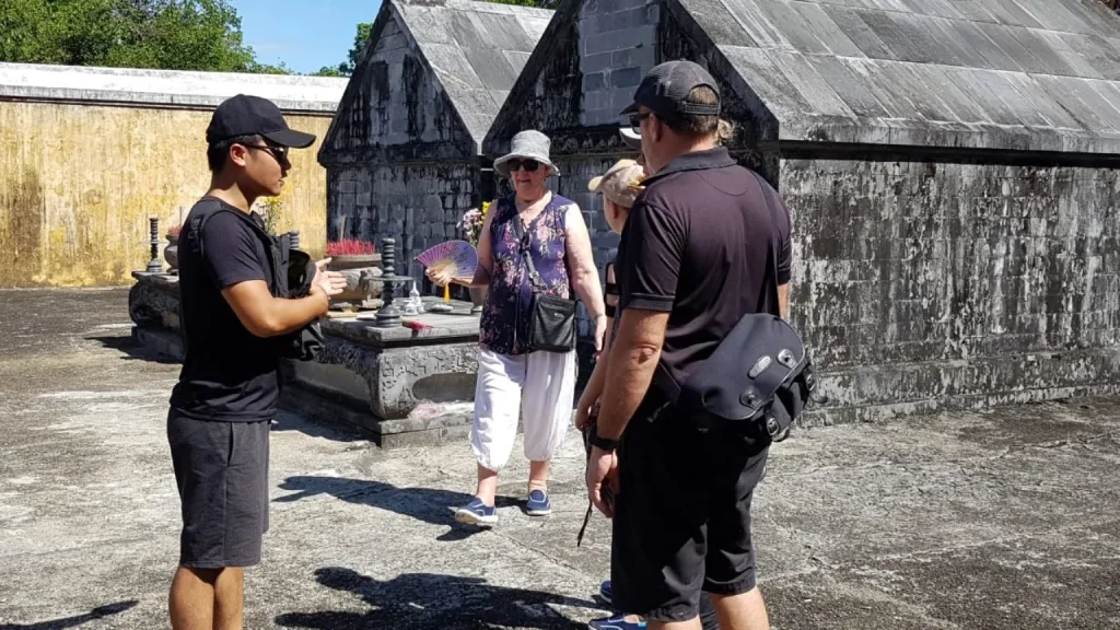 Is Hue worth visiting - Licensed guide Ngoc Luu explaining Hue history to travellers at Gia Long tomb